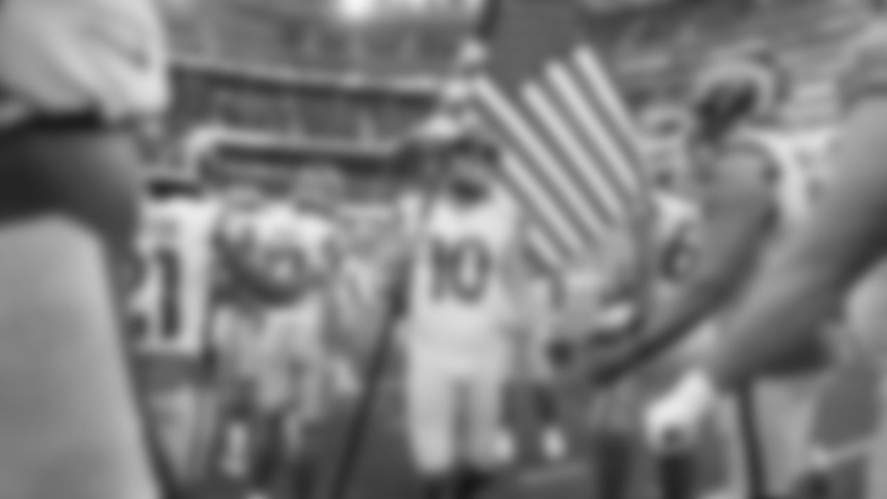 Los Angeles Rams wide receiver Cooper Kupp (10) high fives teammates as he holds an American flag prior to an NFL football game against the Tennessee Titans, Sunday, Nov. 7, 2021 in Inglewood, Calif. The Titans won 28-16. (Ben Liebenberg via AP)